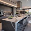 The contemporary island in this kitchen, surrounded by stylish bar stools, adds flair to the home.