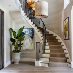 A stunning helix staircase crafted from dark walnut, offering both a sculptural element and functional elegance to the foyer