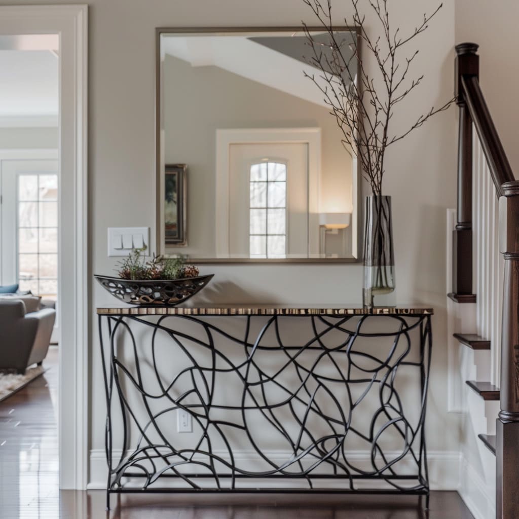The entrance of this home features a metal console table and a big handcrafted mirror