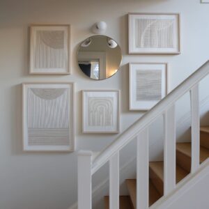 How to Create a Stairwell Gallery Wall That Matches the Movement of The Home