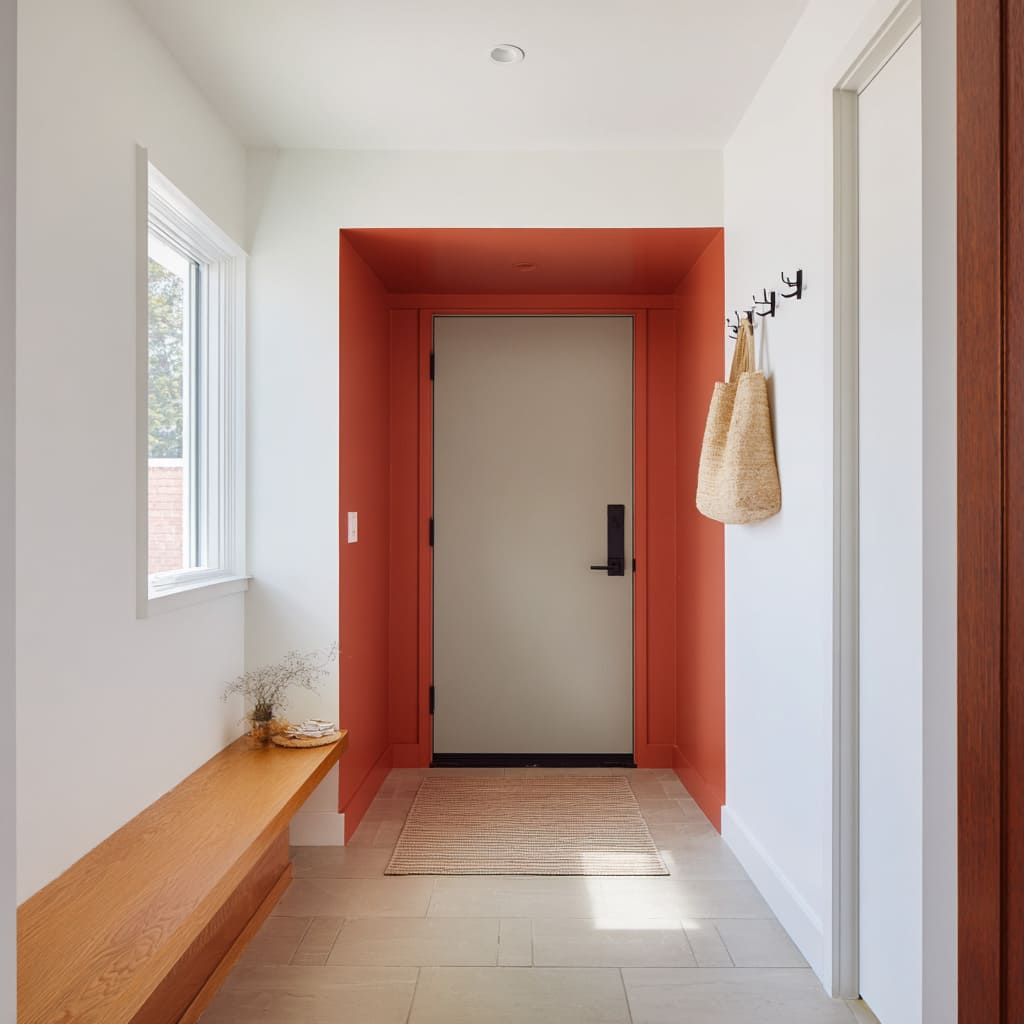 Greige door with terracotta surround as a color portal Greige door with terracotta surround as a color portal