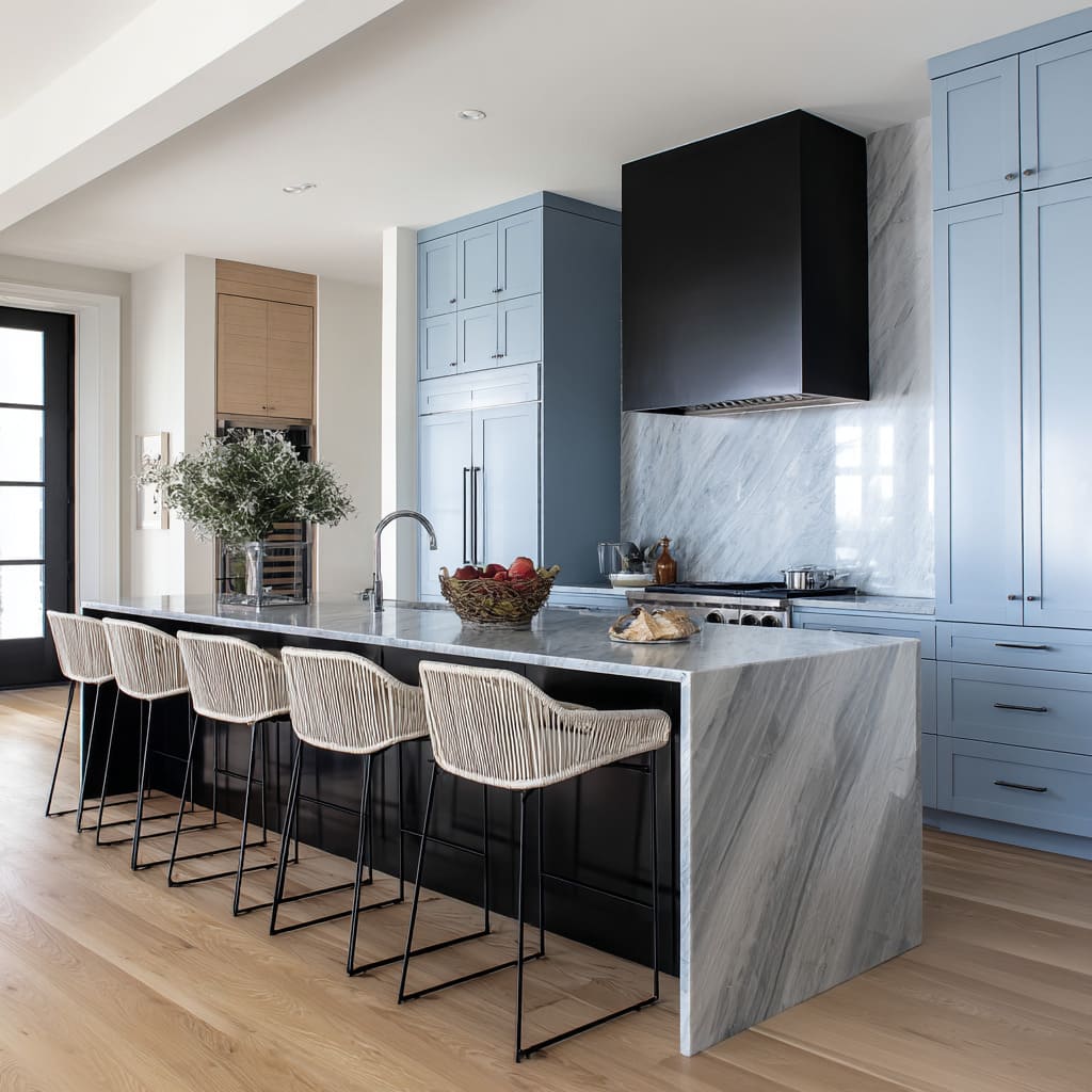 Soft blue kitchen ideas with feathery marble island and sand-colored cord stools on black steel frames echoing stone bevels
