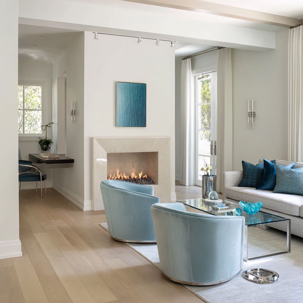 Transitional silver and blue living room concept with aqua barrel chairs, ivory sofa with teal pillows Transitional silver and blue living room concept with aqua barrel chairs, ivory sofa with teal pillows