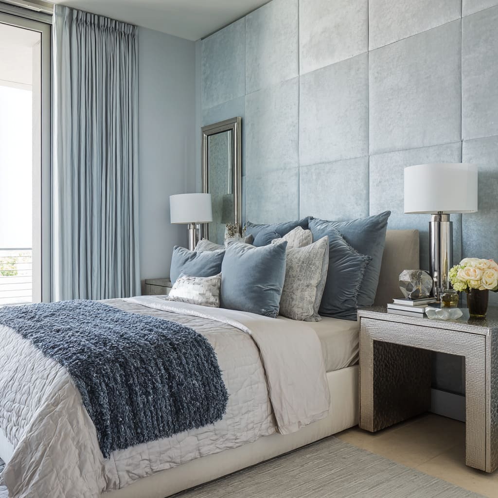 paneled headboard wall design with blue bedding, mirrored nightstands, and chrome lamps paneled headboard wall design with blue bedding, mirrored nightstands, and chrome lamps