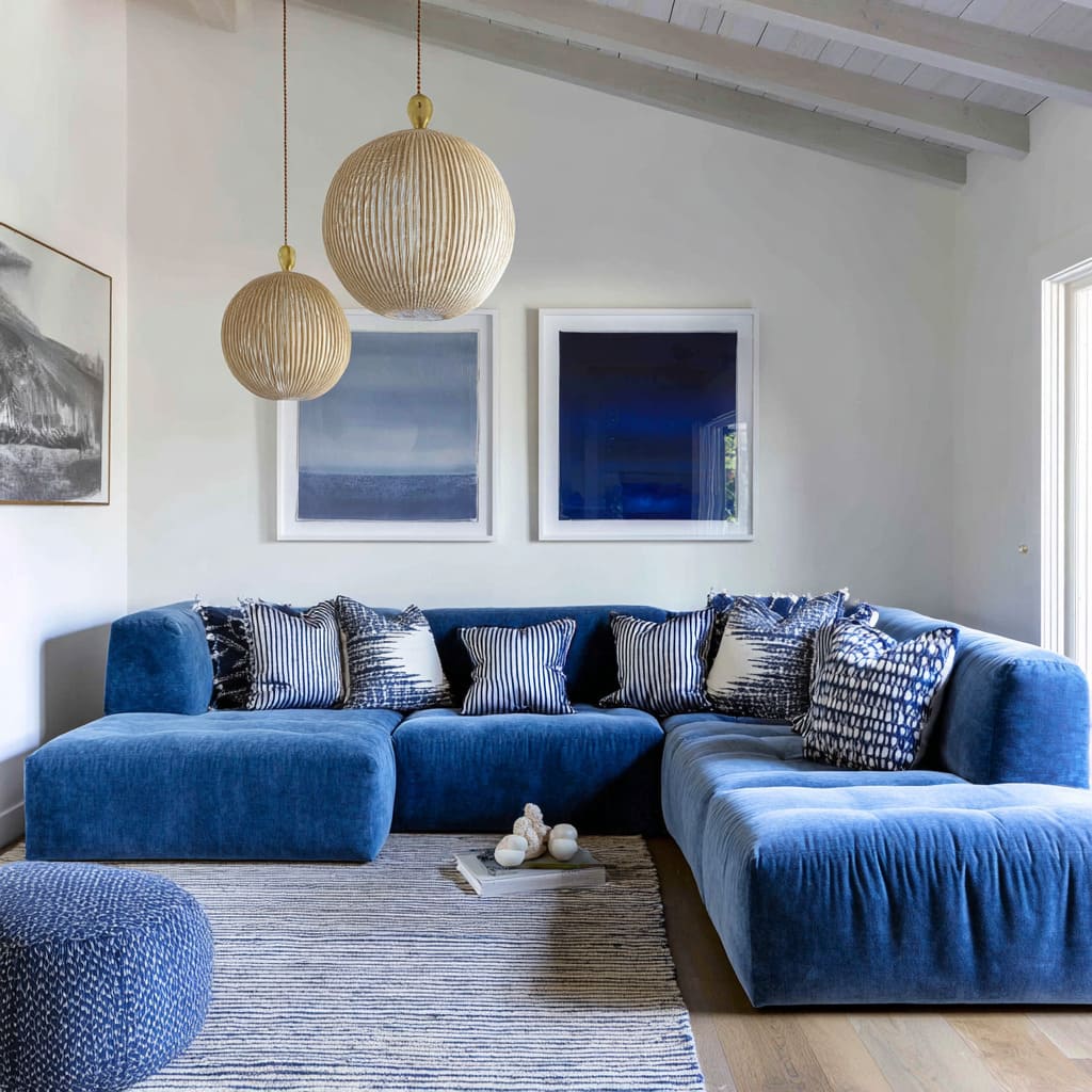 Bright blue sectional with a row of navy and black-white patterned cushions for a modern graphic pillow mix Bright blue sectional with a row of navy and black-white patterned cushions for a modern graphic pillow mix