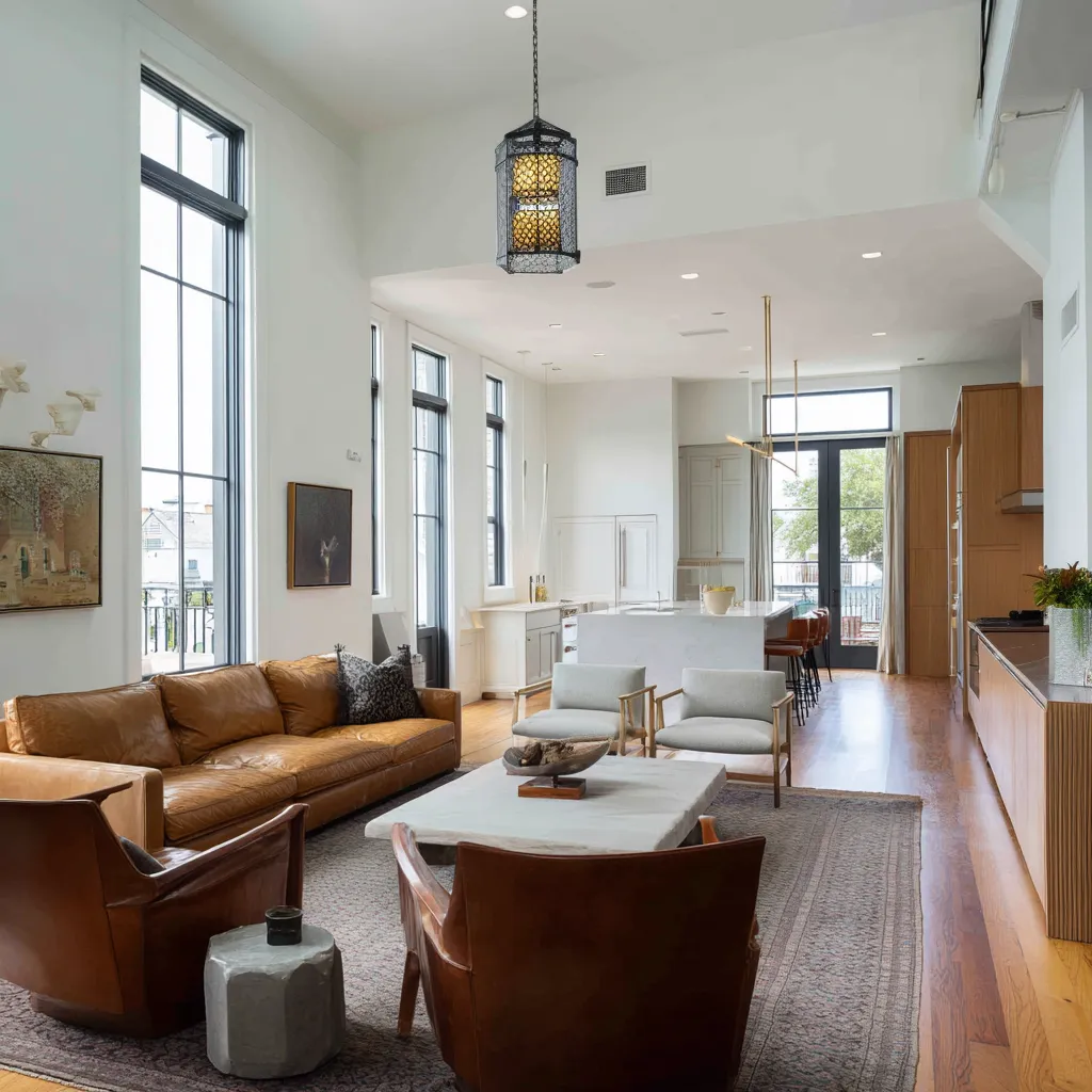 double-height open-plan room design with New Orleans window language in a loft-like layout double-height open-plan room design with New Orleans window language in a loft-like layout